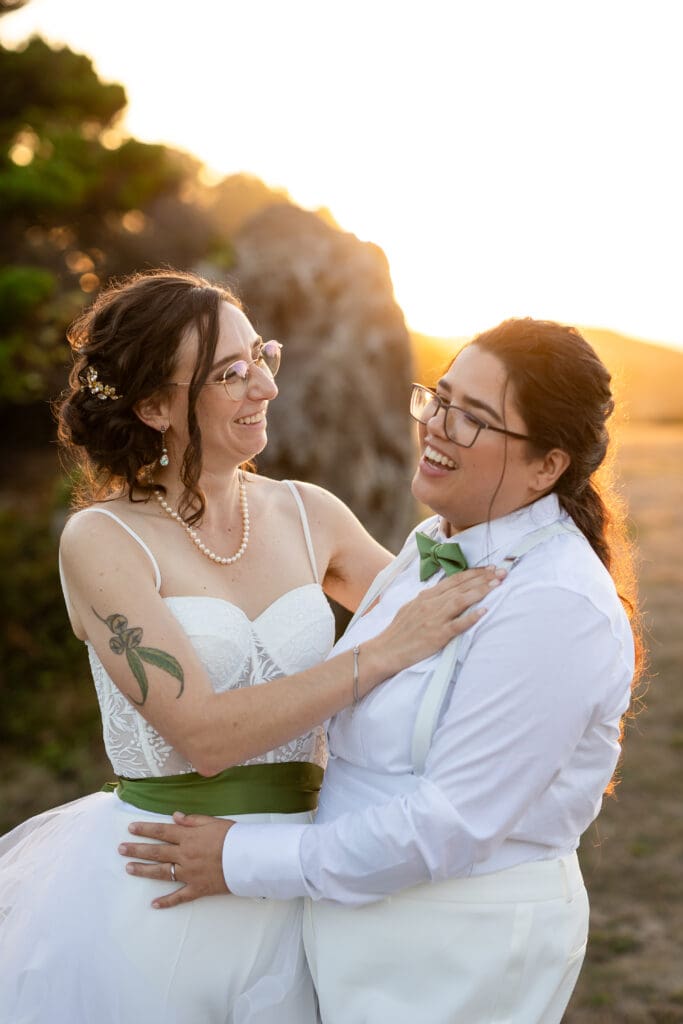 Brides smiling and laughing at golden hour portraits for Fort Bragg wedding
