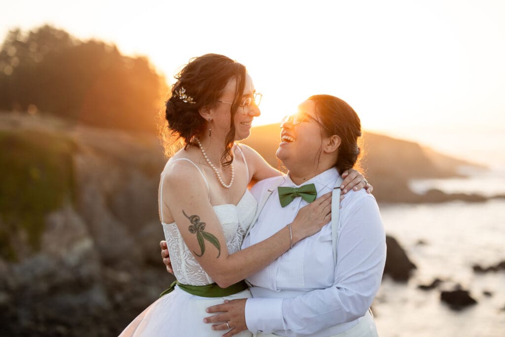 Golden hour brides smiling at each other at Fort Bragg wedding
