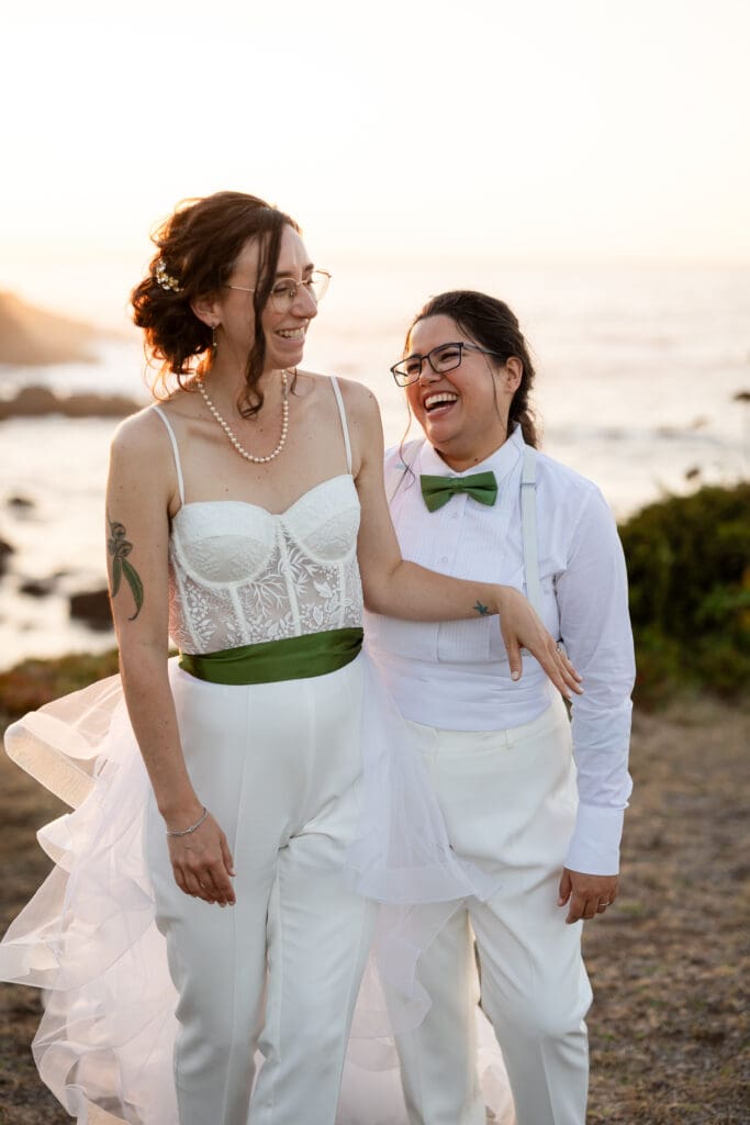 Brides walking in front of the water and laughing at Fort Bragg wedding