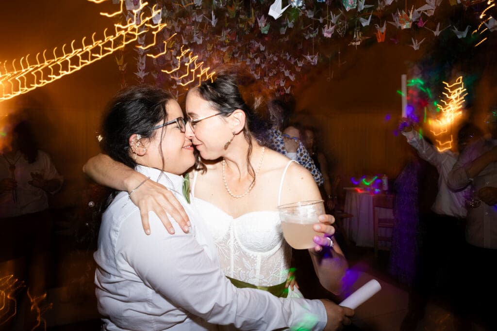 Brides touching noses and dancing at Holly’s Ocean Meadow in Fort Bragg, CA