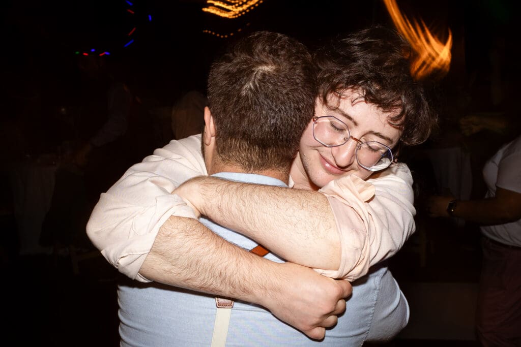 Bride hugging wedding guest at Fort Bragg wedding reception