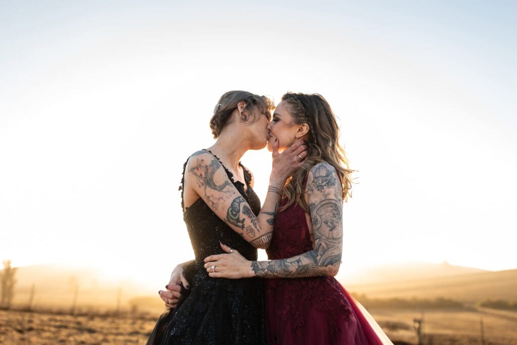 Brides kissing at Petaluma wedding venue at Olympia's Valley Estate