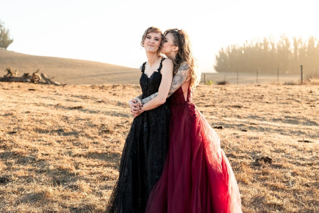 Brides holding each other at Olympia's Valley Estate