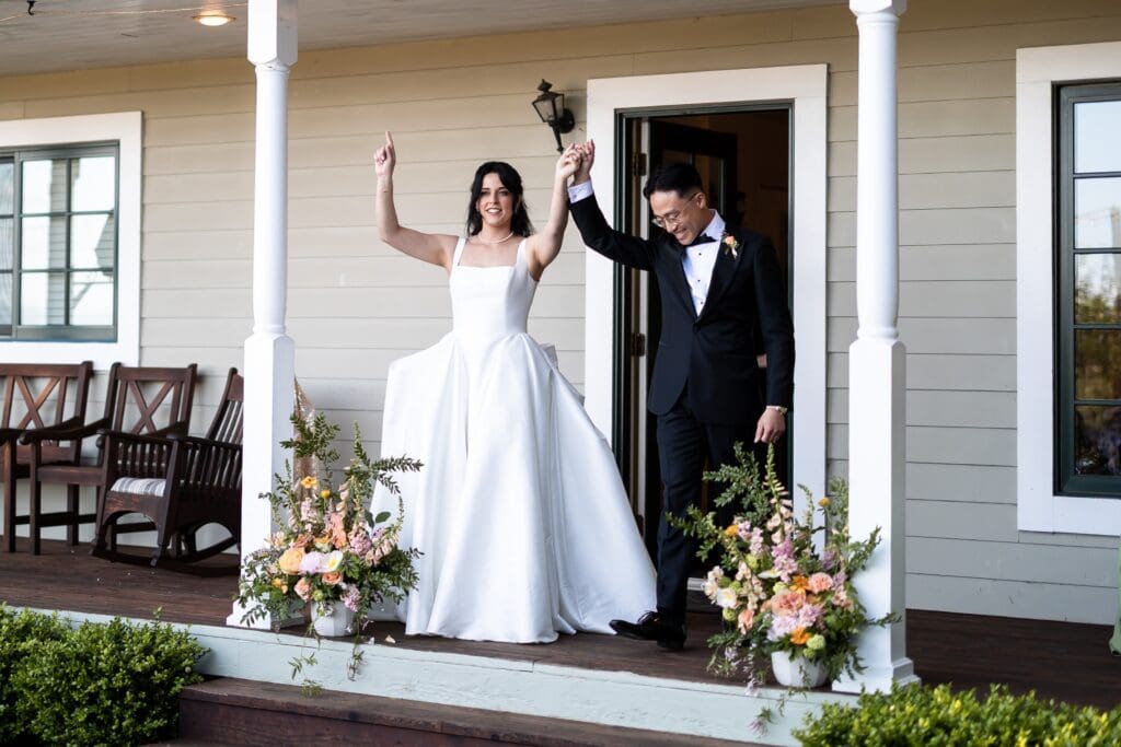 Bride and groom holding hands at wedding ceremony at Vine Hill House in Sonoma County