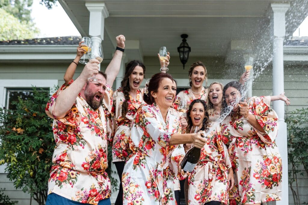 Wedding party spraying champagne at Vine Hill House in Sonoma County