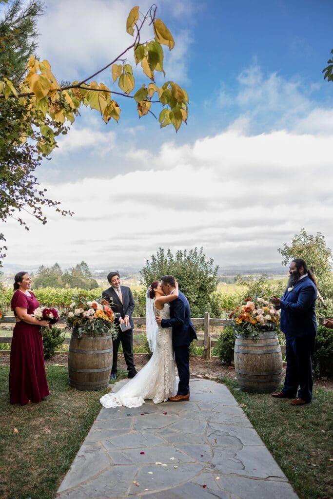 Bride and groom kissing at wedding ceremony at Vine Hill House in Sonoma County