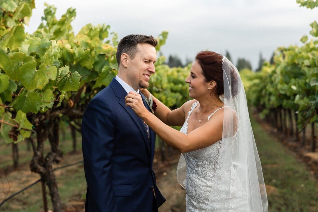 Bride adjusting bow tie at wedding reception at Vine Hill House in Sonoma County