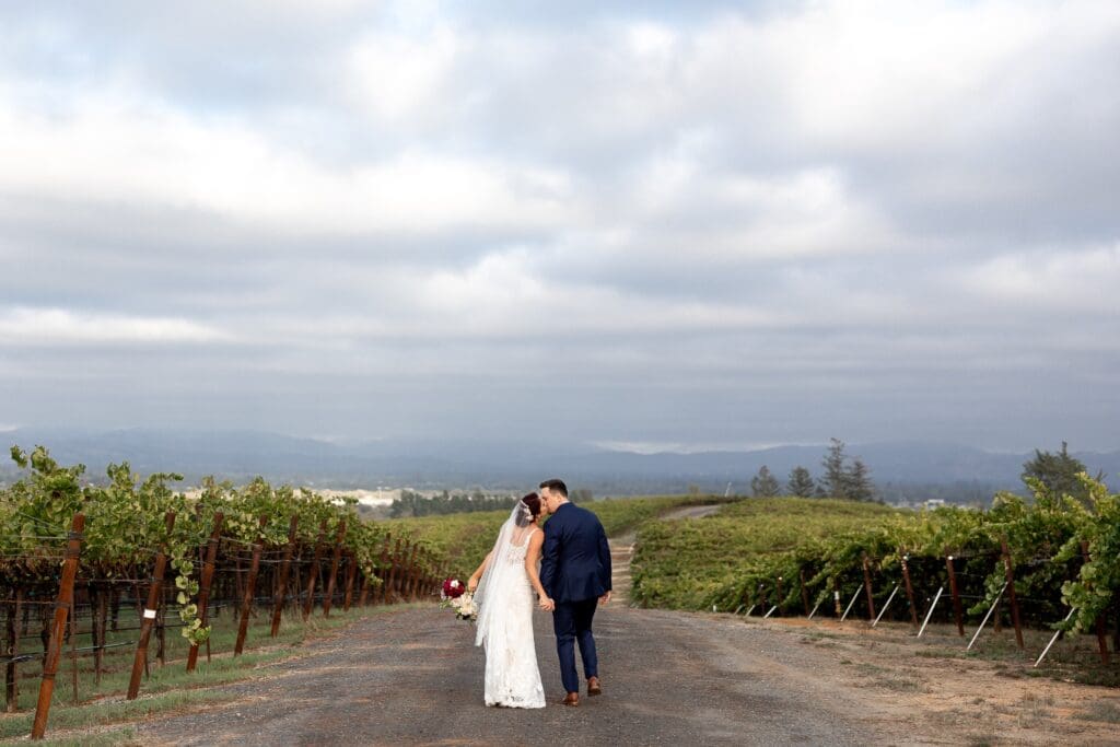 Big skies and couple holding hands at Vine Hill House in Sonoma County