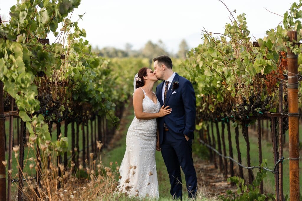 Bride and groom kissing at Vine Hill House wedding venue in Sonoma County