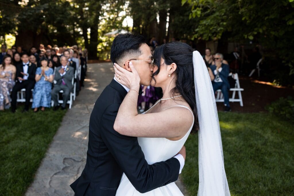 Bride and groom kissing at wedding ceremony at Vine Hill House in Sonoma County