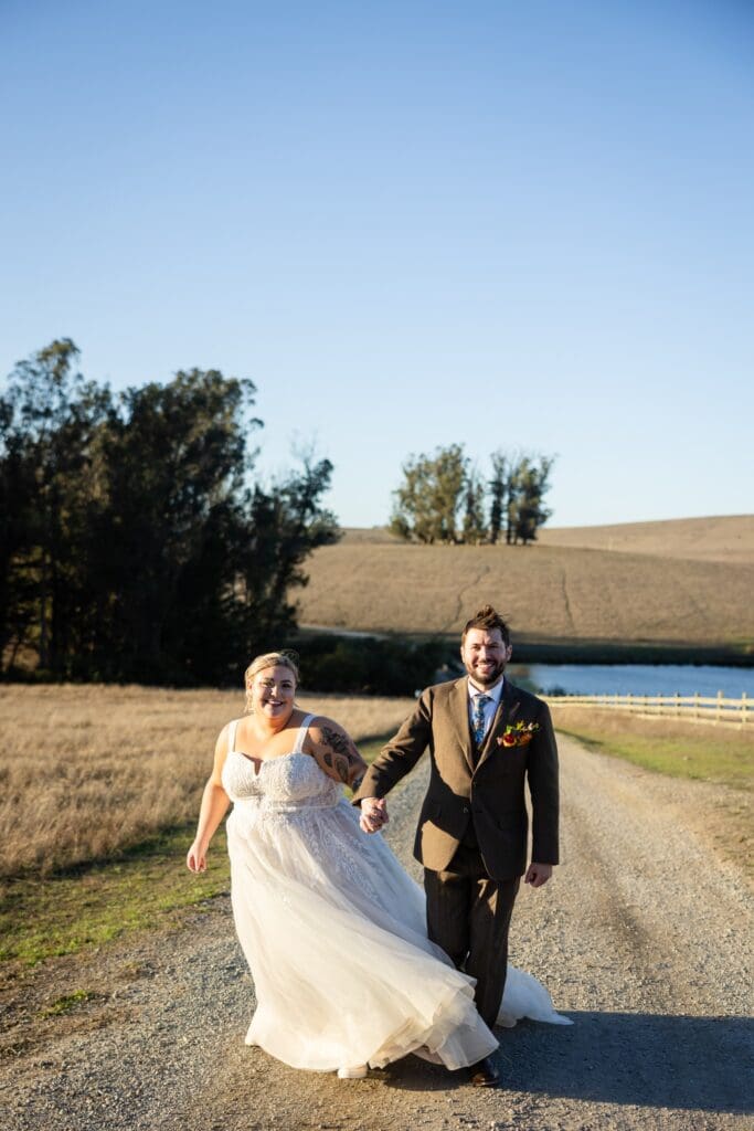 Bride and groom holding hands at Northern California wedding venue The Haven at Tomales