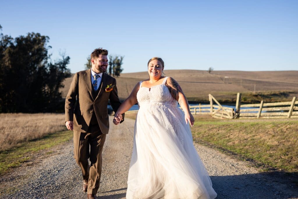 Bride and groom holding hands on The Haven at Tomales property