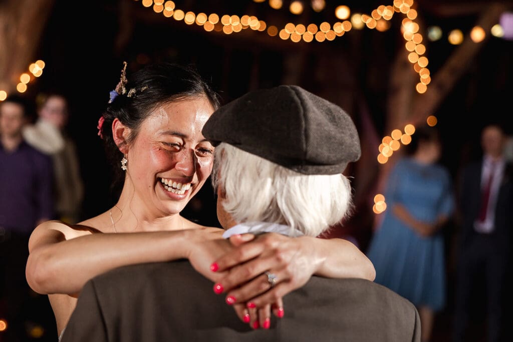 Wedding guests dancing at a Mendocino wedding reception inside the lodge