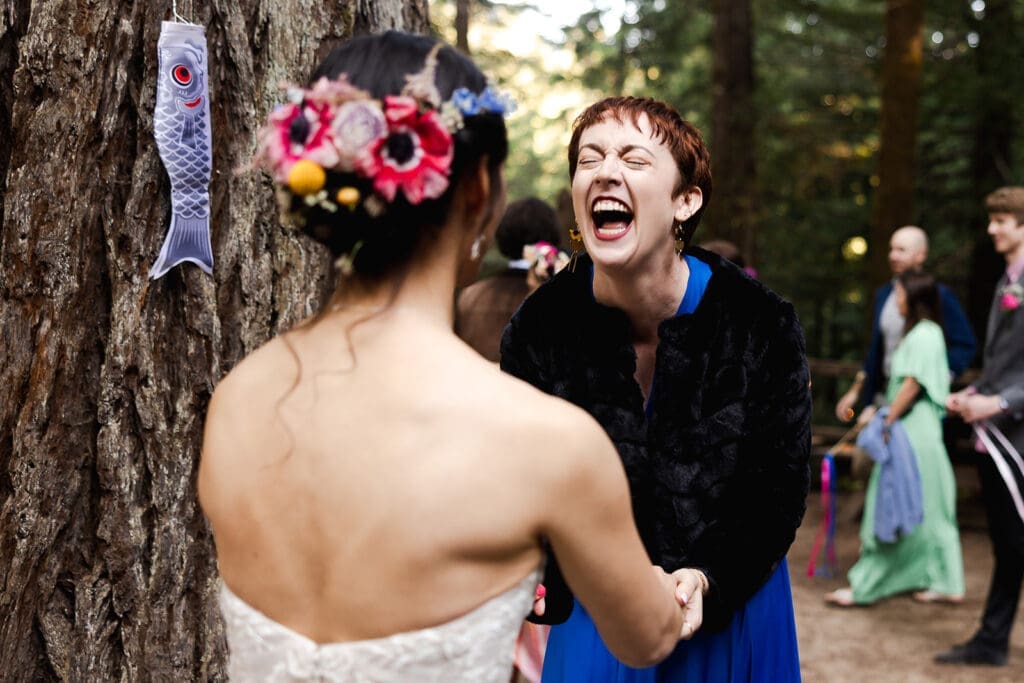 Guests reconnecting during cocktail hour at a Mendocino Woodlands wedding venue