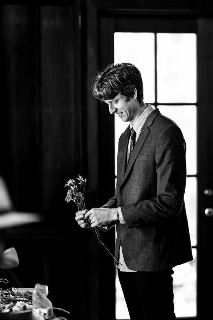 Guests making their own boutonnieres at a Mendocino Woodlands wedding retreat