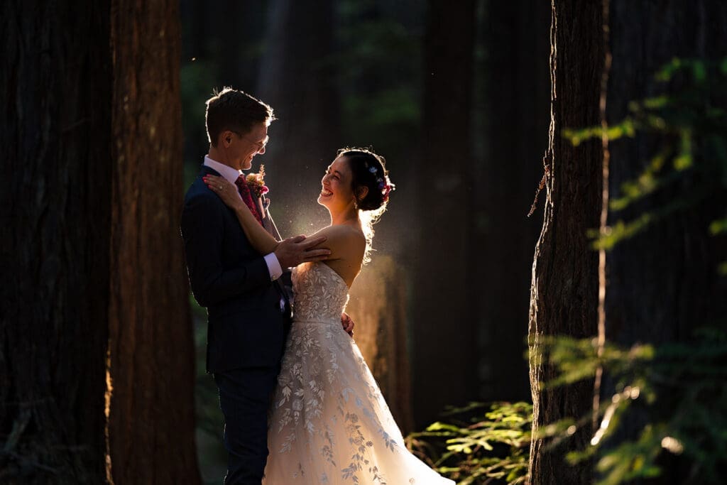 Creative flash portrait of the couple embracing in the trees at Mendocino Woodlands