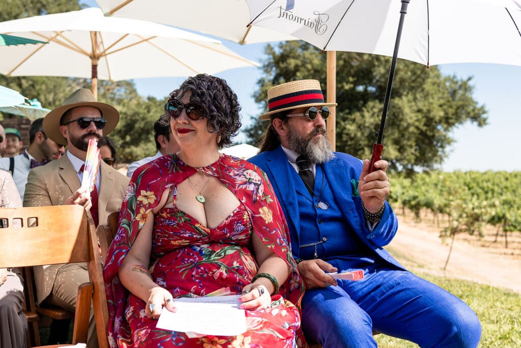 Guests holding colorful parasols during a summer wedding ceremony in Sonoma County