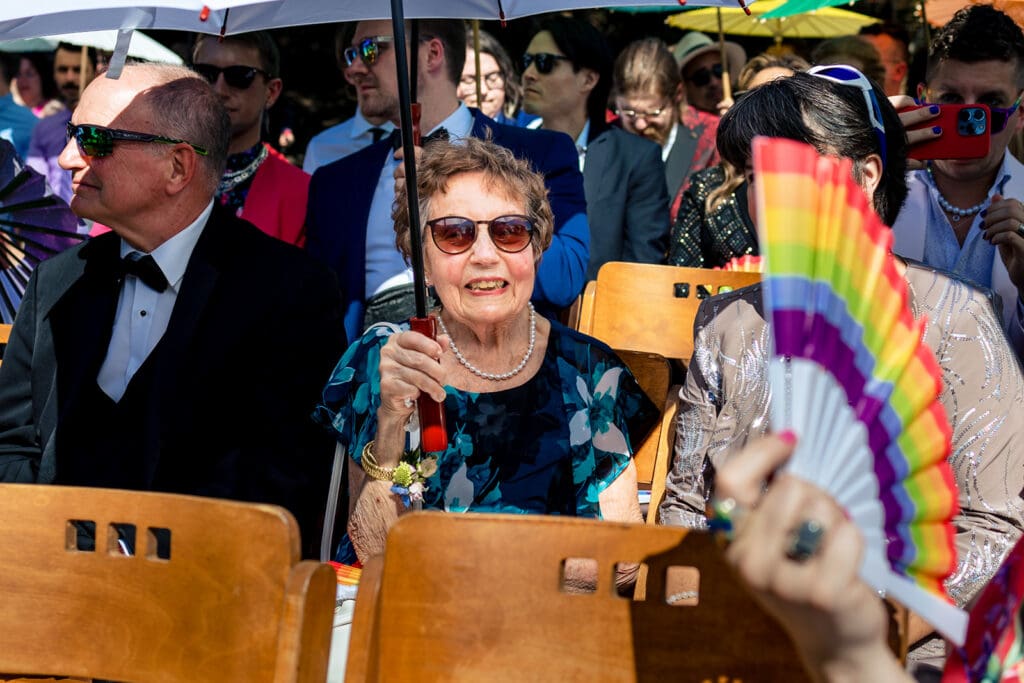 Guests holding colorful parasols during a summer wedding ceremony in Sonoma County