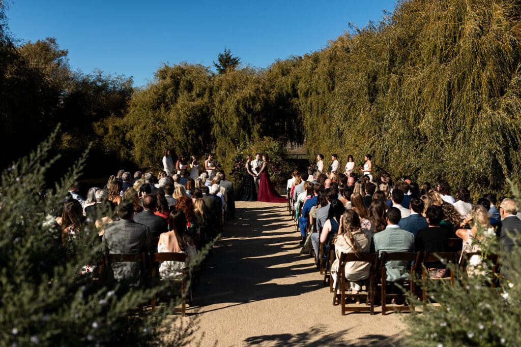 Outdoor wedding ceremony overlooking pond at Olympias Valley Estate Petaluma