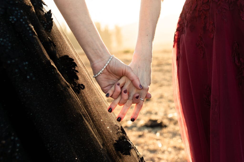 LGBTQ Brides in black and burgundy gowns at Olympias Valley wedding in Petaluma during Golden Hour.