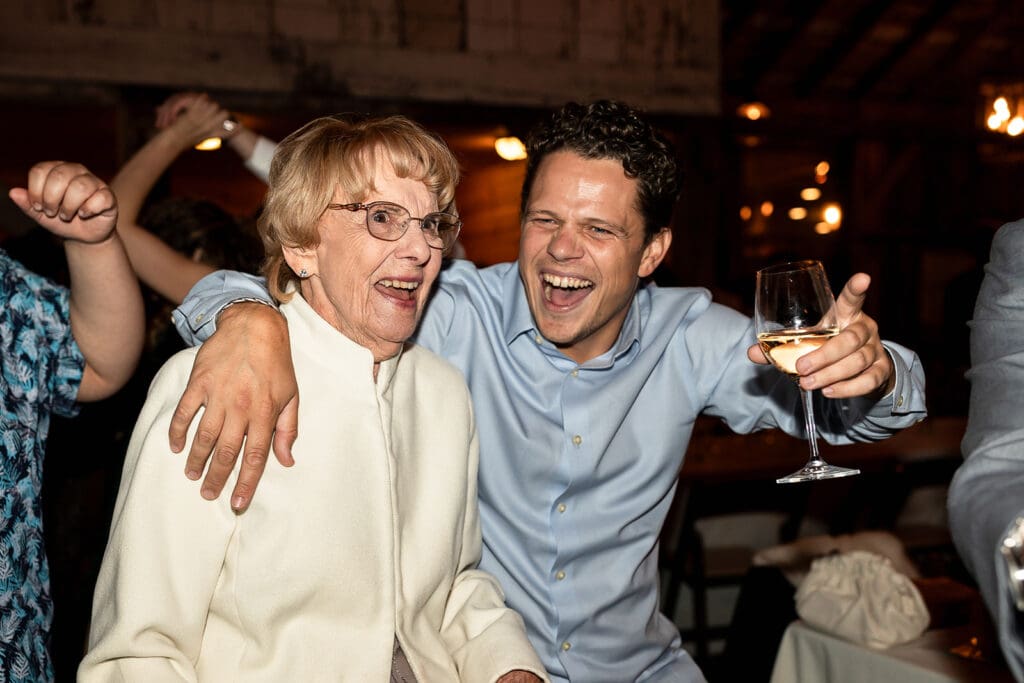 Guests dancing at barn reception at Olympias Valley Estate wedding