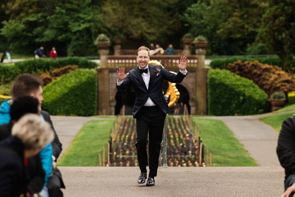 Groom walks down the aisle as San Francisco Conservatory of Flowers wedding ceremony.