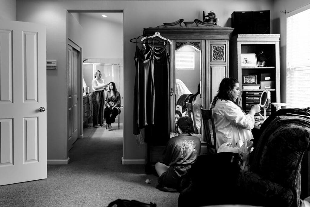 Wide view of bride getting ready at home with friends for her intimate Petaluma wedding.
