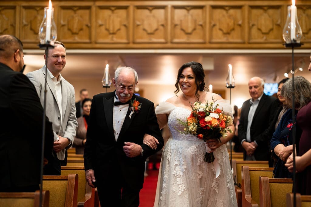 Bride's father walks her down the aisle at wedding ceremony at Elim Church, Petaluma.