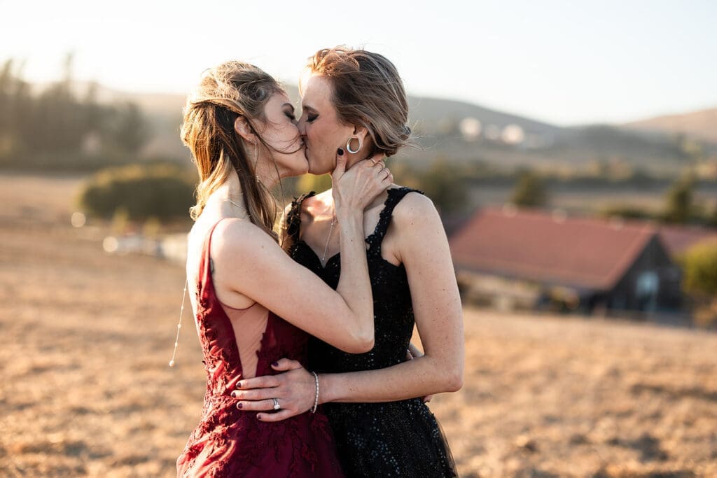 LGBTQ Brides in black and burgundy gowns at Olympias Valley wedding in Petaluma during Golden Hour.