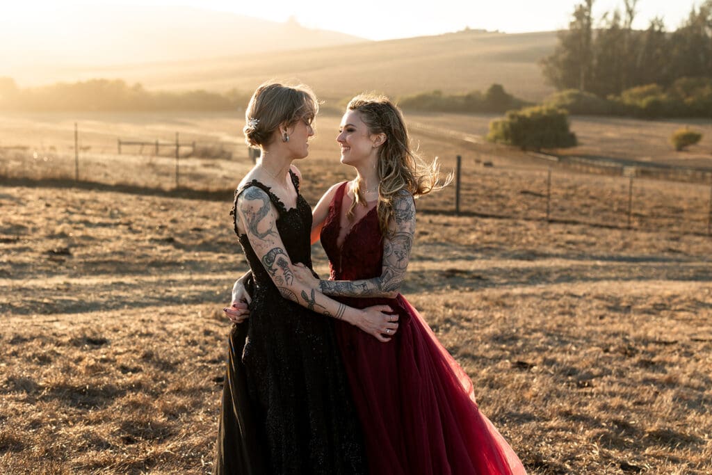 LGBTQ Brides in black and burgundy gowns at Olympias Valley wedding in Petaluma during Golden Hour.