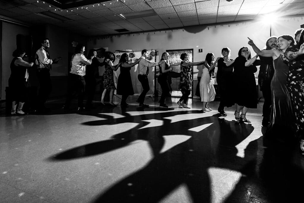 high contrast black and white image of a conga line on the dancefloor at a Petaluma Wedding.