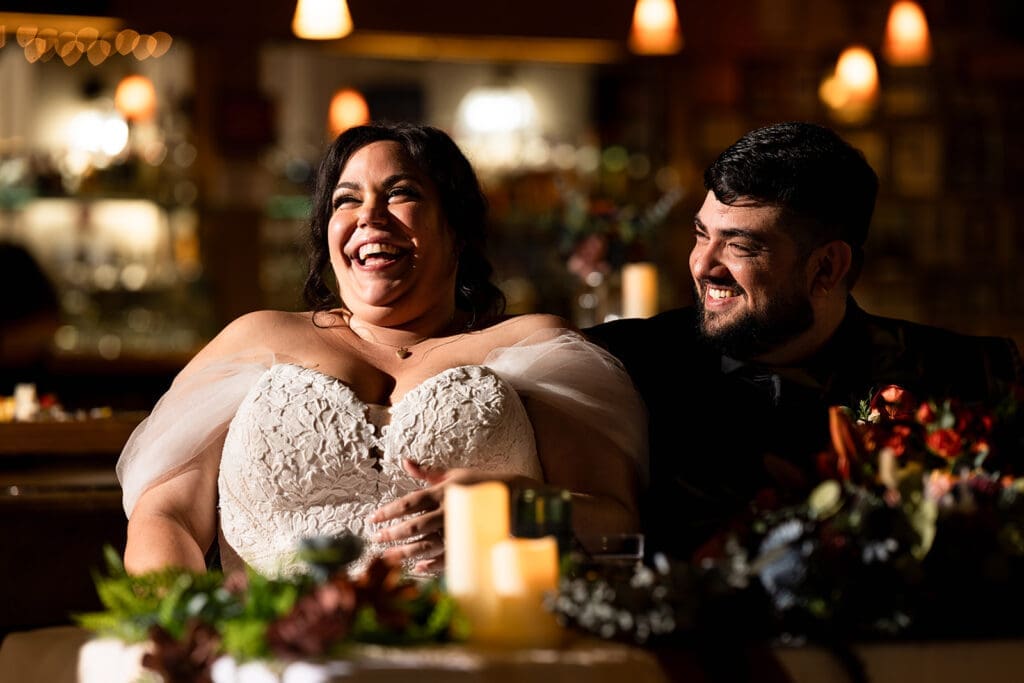 Bride and groom share a laugh during the speeches at their Elks Lodge wedding reception in Petaluma. 