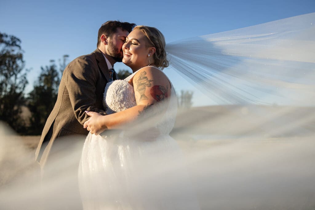 COuple embraces the wind in wedding portraits at The Haven, TOmales
