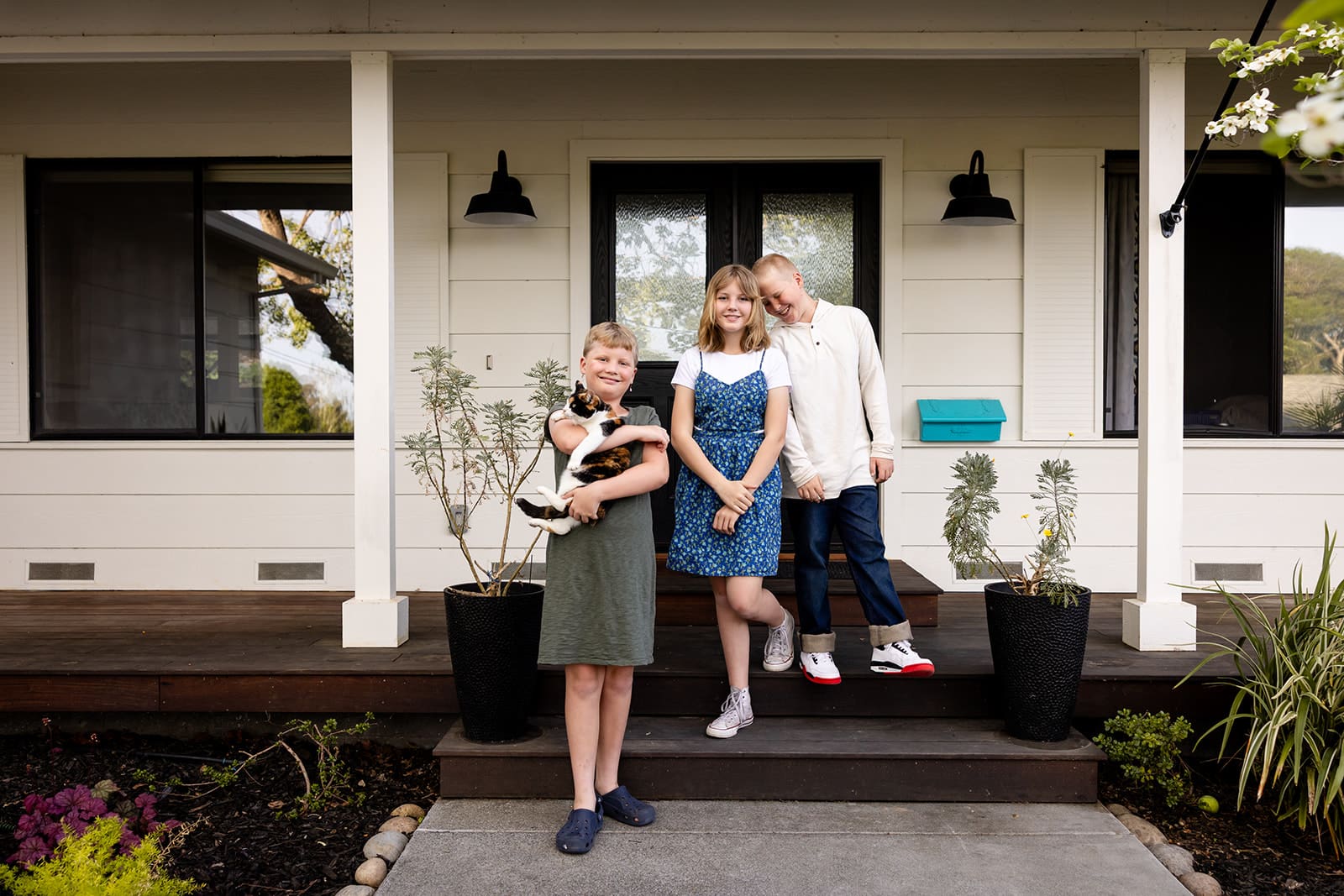 Sonoma County Family poses for portrait in front of their Petaluma Home