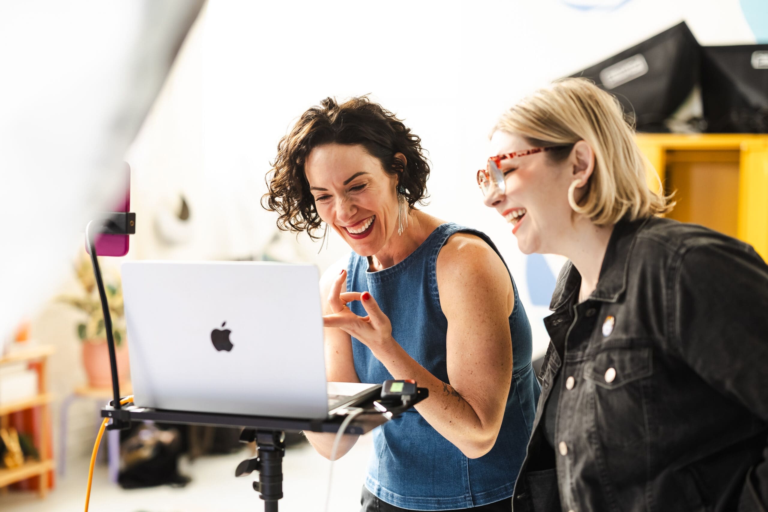 Sonoma County wedding photographers Loren Hansen and Holly B. Rose laughing at a computer screen