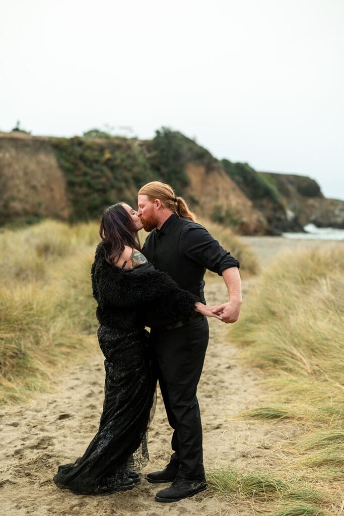 Bride and groom sharing a private moment on the Mendocino beach after their wedding ceremony