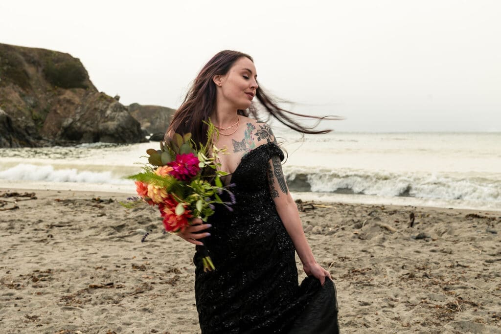 Bride in black wedding dress and Doc Martens on the Mendocino Coast beach