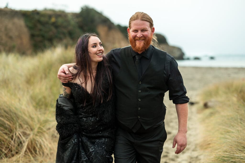 Bride and groom sharing a private moment on the Mendocino beach after their wedding ceremony