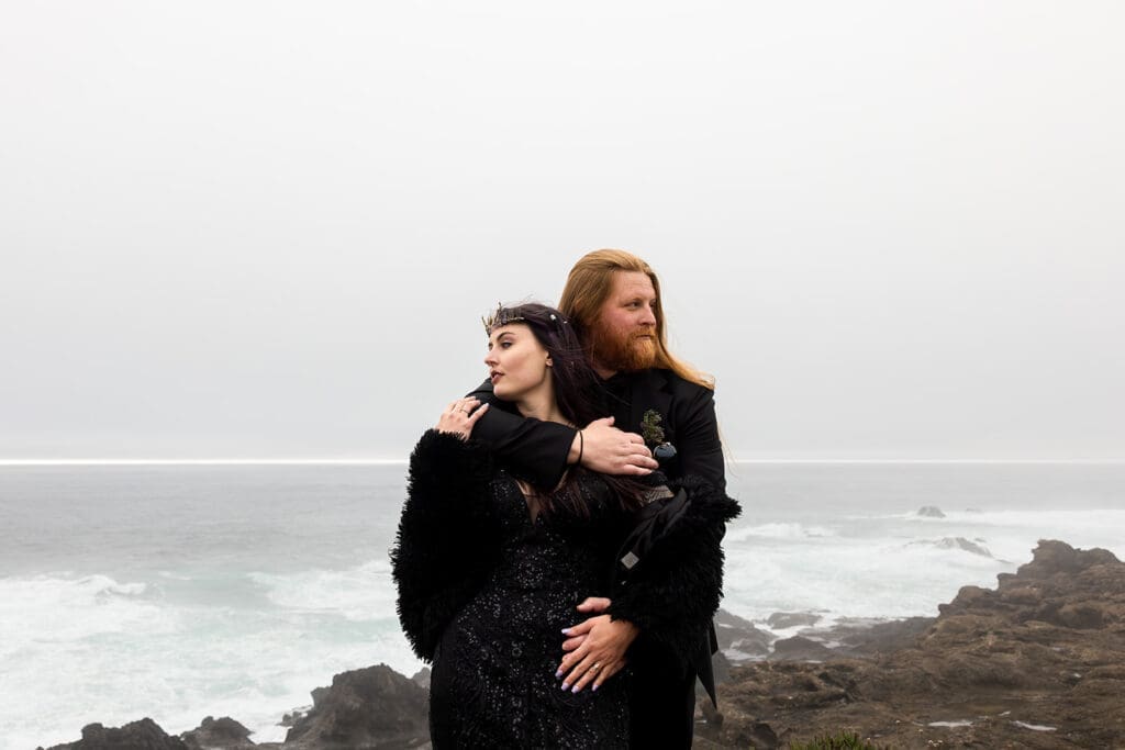 Couple poses against the Mendocino Coast for their Point Cabrillo Lighthouse Wedding ceremony.