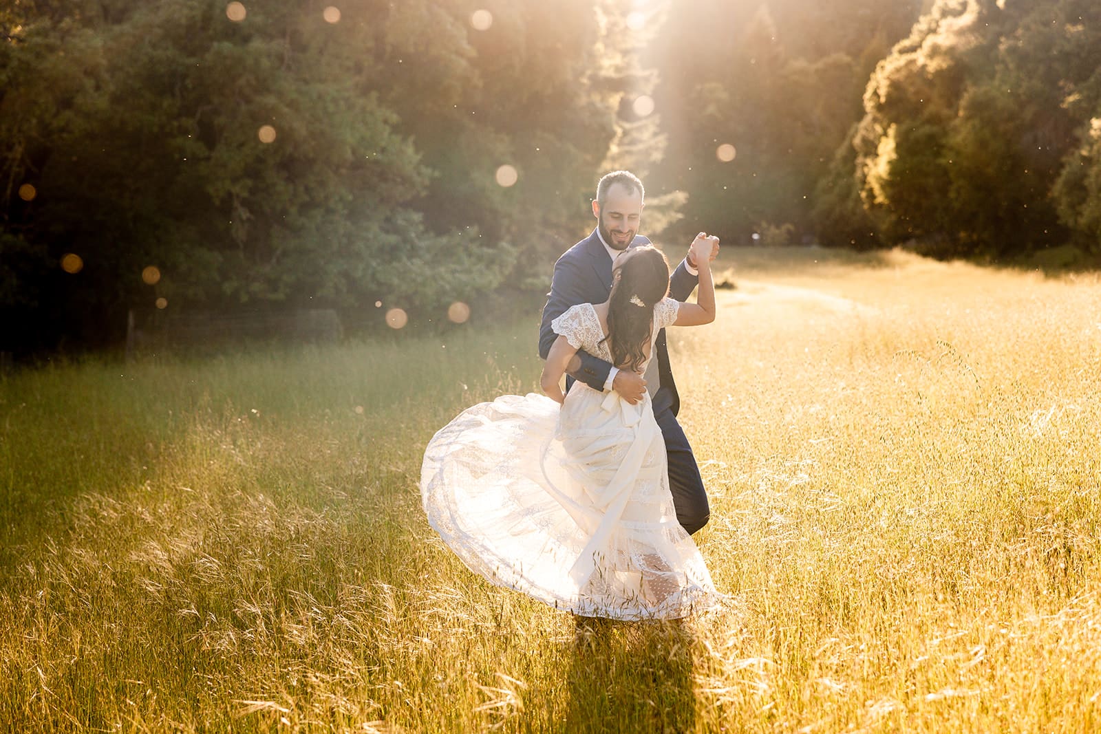Couple dances in meadow at their River's Bend Retreat Wedding in Mendocino.