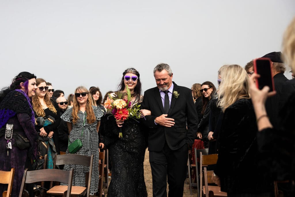 Father walking bride down the aisle at foggy Point Cabrillo Lighthouse wedding