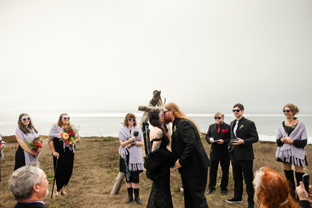 Bride and groom first kiss in the fog at Point Cabrillo Lighthouse Mendocino wedding