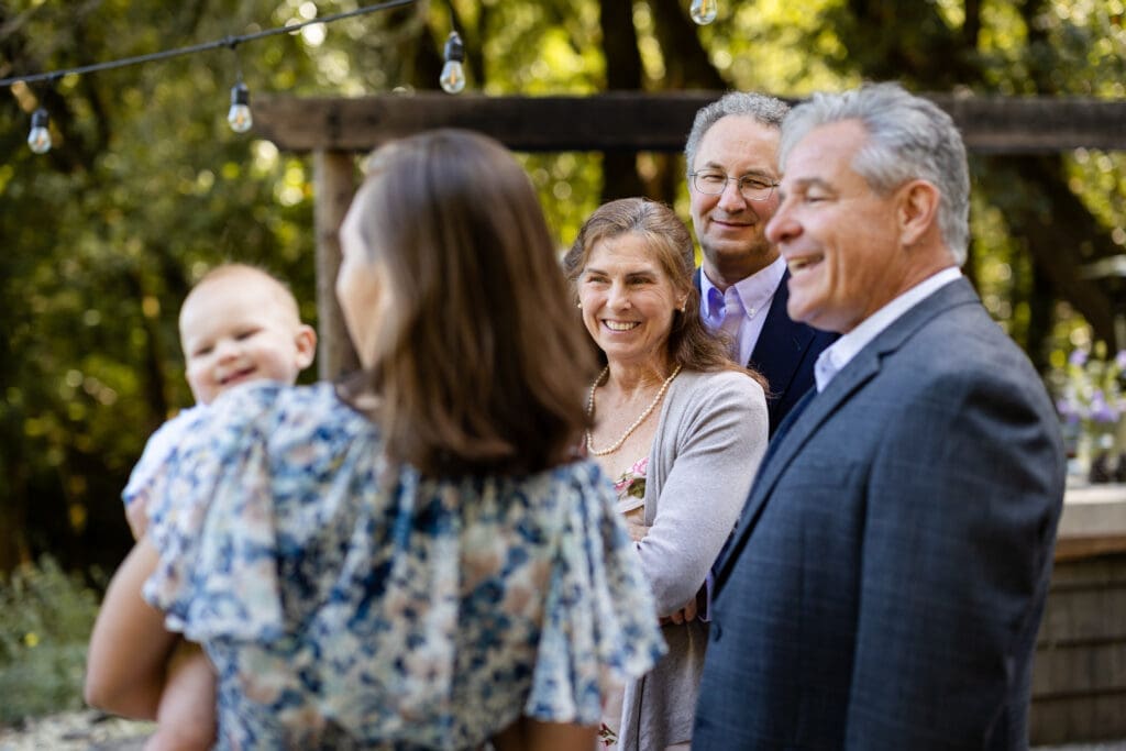 Wedding guests at lakeside cocktail hour at Leonard Lake Reserve in Mendocino County