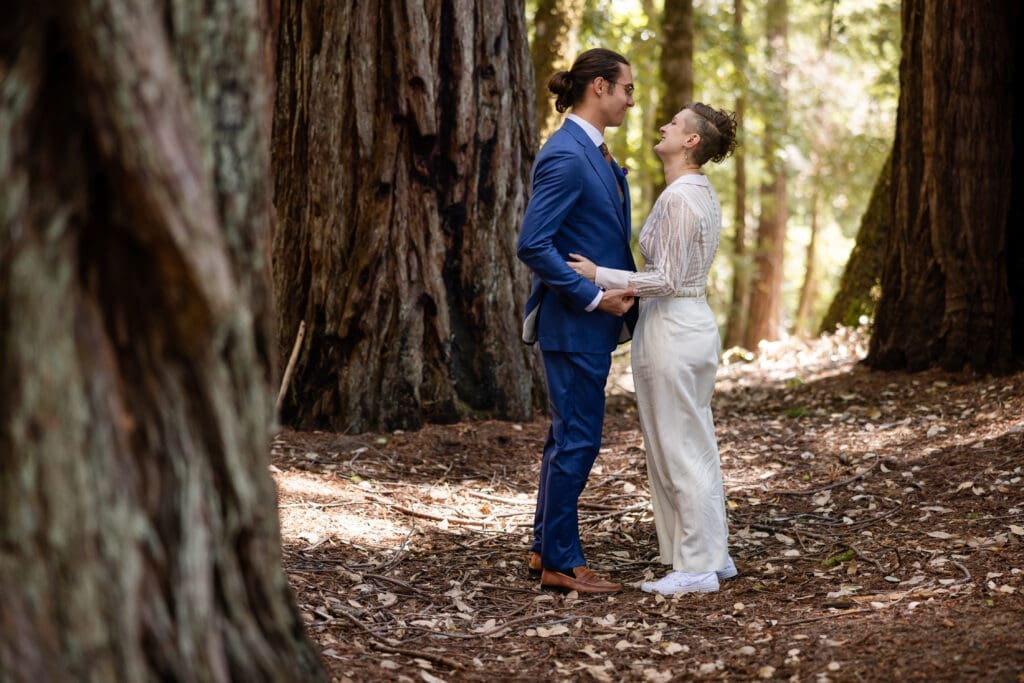 Couple sharing a first look inside a fairy ring of redwoods at Leonard Lake Reserve