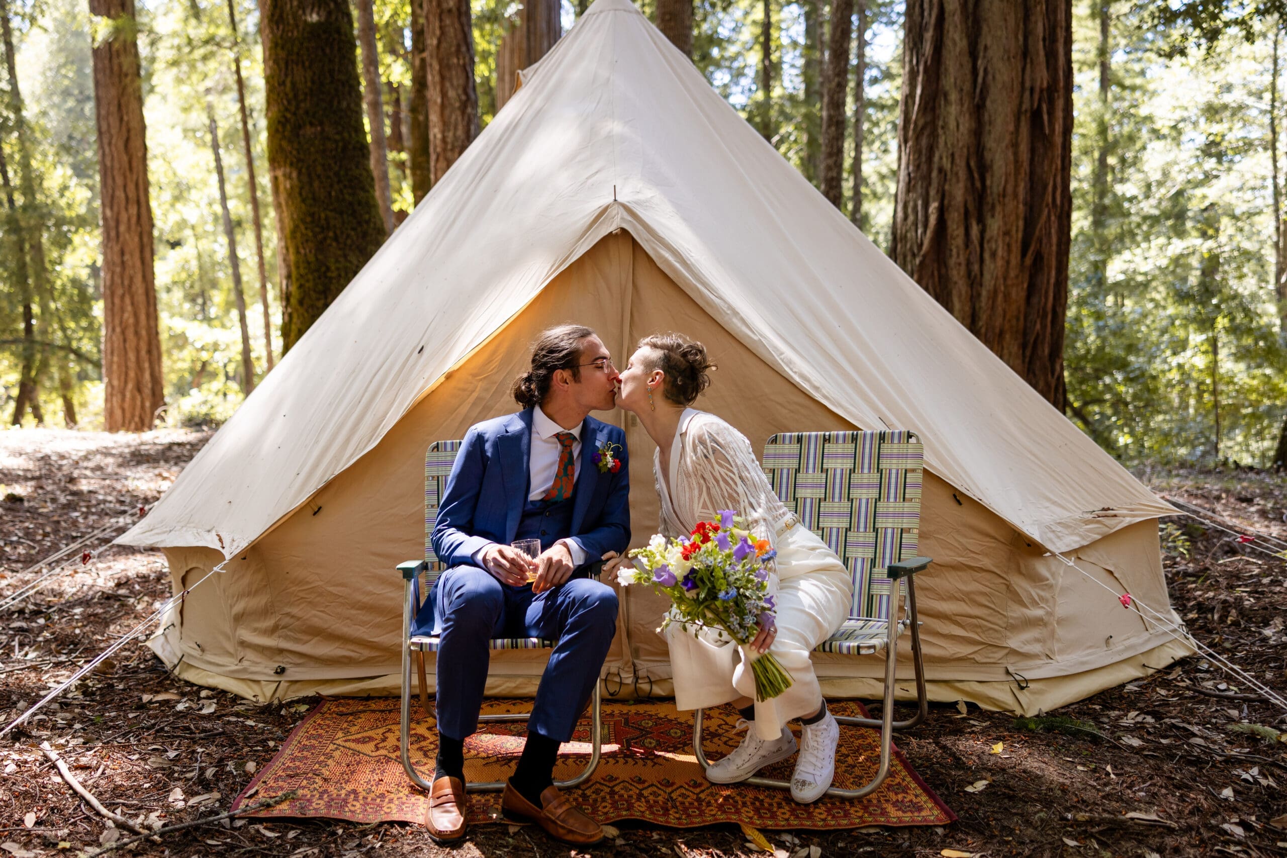 Bride and Groom at Leonard Lake Reserve share a kiss in front of their tent at retreat wedding