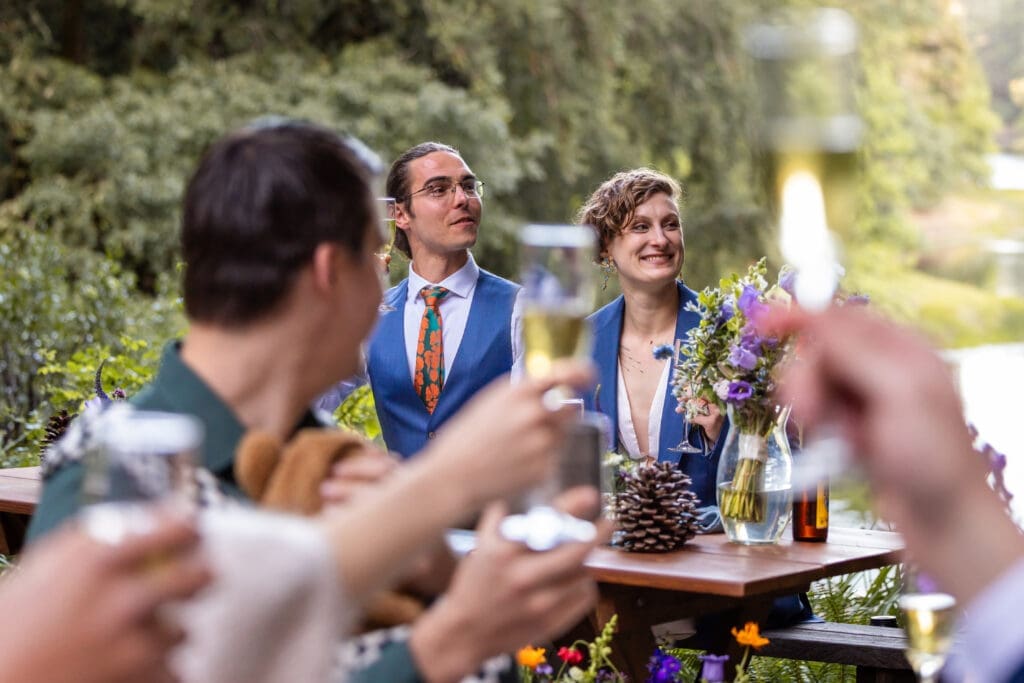 Outdoor wedding reception dinner overlooking Leonard Lake in the Mendocino redwoods
