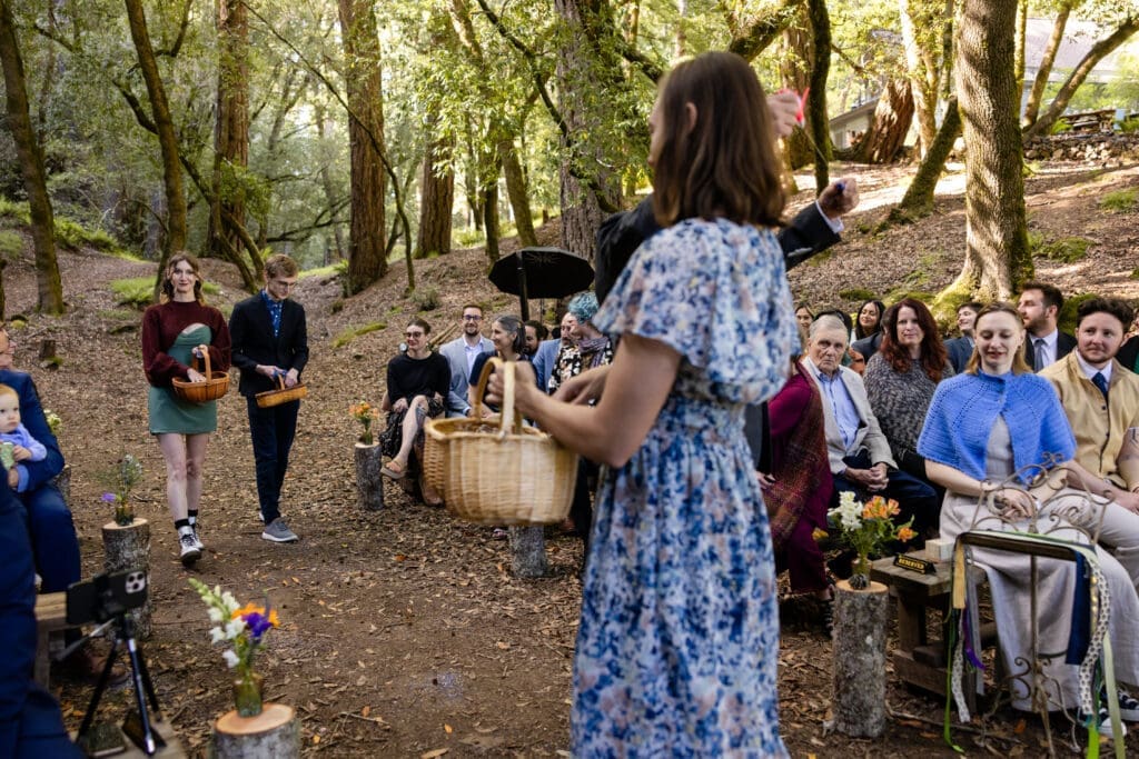 Outdoor wedding ceremony under oak trees with Leonard Lake in the background