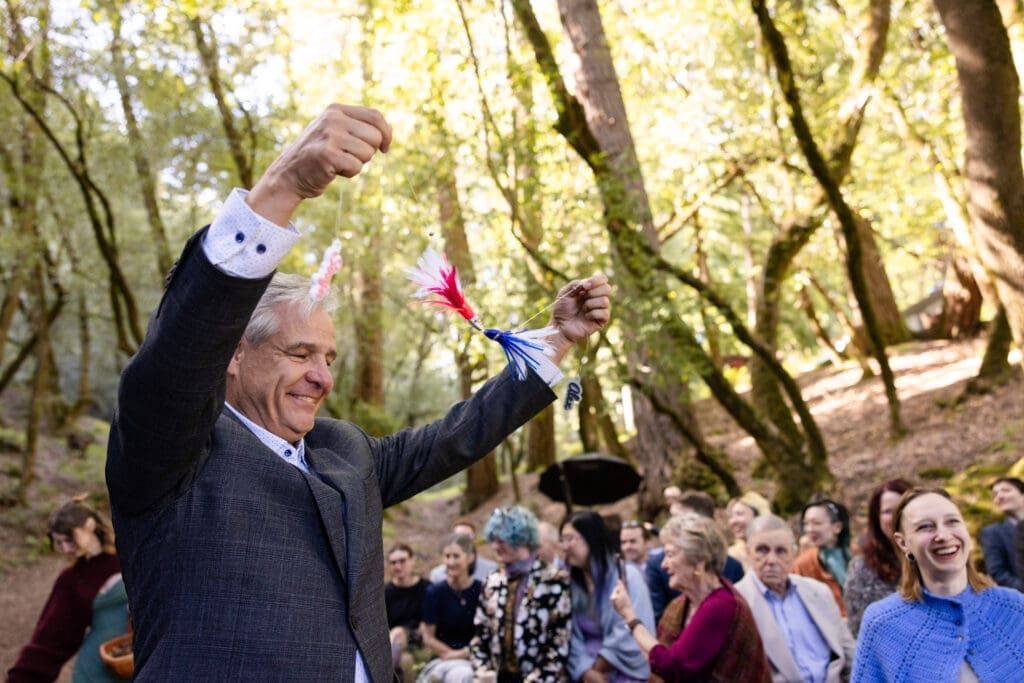 Outdoor wedding ceremony under oak trees with Leonard Lake in the background