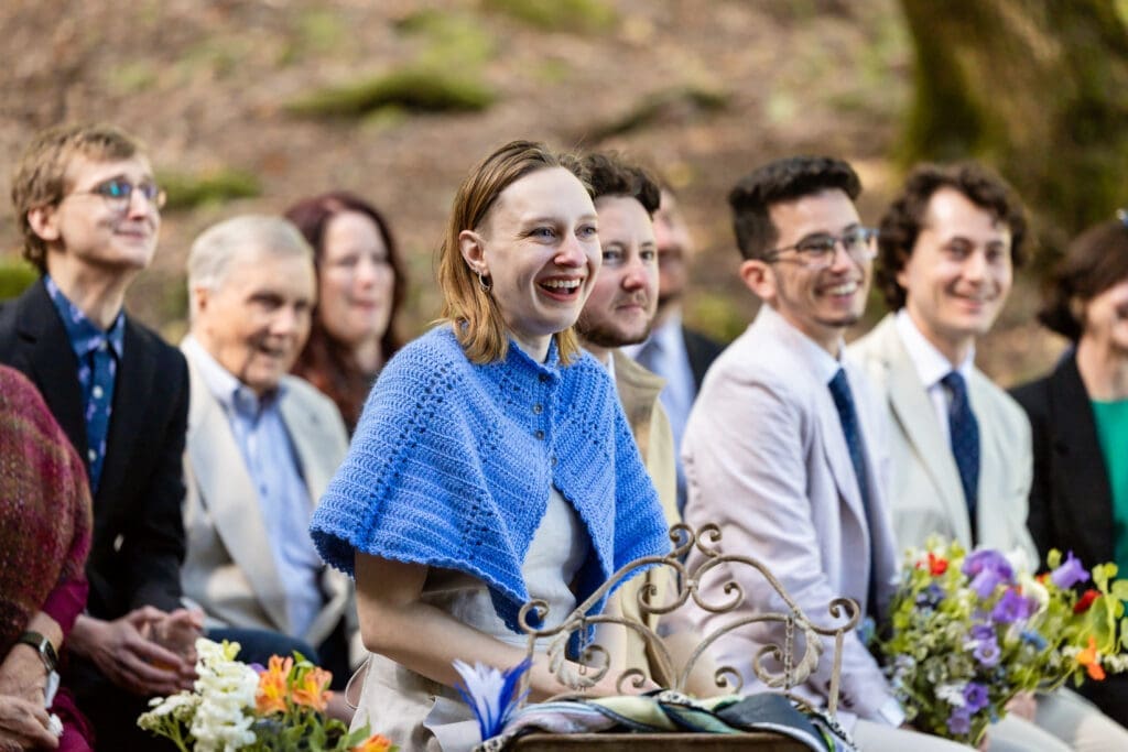 Outdoor wedding ceremony under oak trees with Leonard Lake in the background