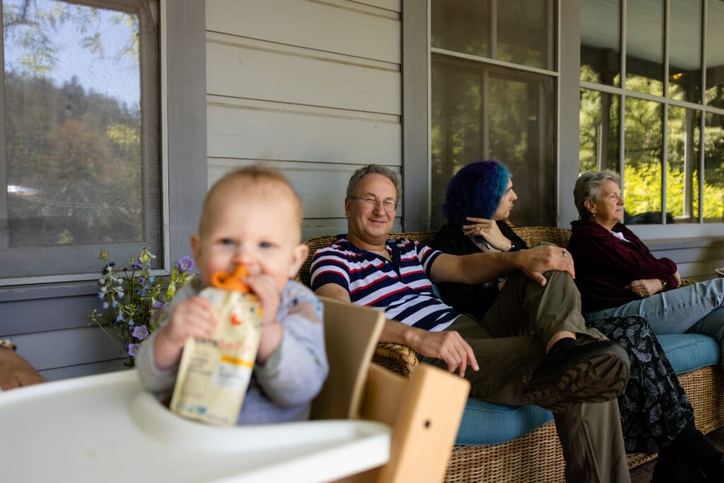 Wedding guests eat lunch on porch at Leonard Lake Reserve